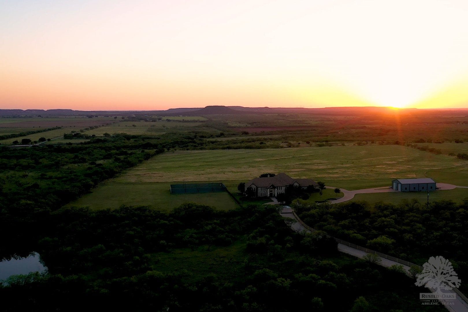 Sunset aerial over the private Rusted Oaks Estate ranch near Abilene Texas